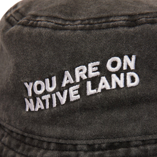 'YOU ARE ON NATIVE LAND' BUCKET HAT
